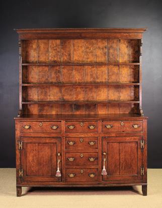 A Late 18th Century Oak Dresser with rack. The plank-backed rack with three plate shelves.