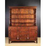 A Late 18th Century Oak Dresser with rack. The plank-backed rack with three plate shelves.