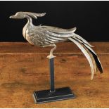 A French Early 17th Century Wrought Iron Phoenix with chased decoration, 13" (33 cm) in length,