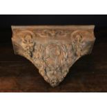 A 19th Century Wooden Wall Bracket carved with medallion portrait of Louis XV within a laurel
