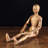 A Small Late 19th Century Wooden Artist's Lay Figure having articulated limbs, and a carved face,