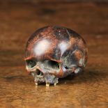 A Small 17th Century Carved Walnut Memento Mori in the form of a skull with inset bone teeth,