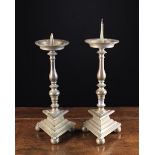 A Pair of 18th Century Silvered Bronze Pricket Candlesticks with acorn knopped baluster stems above