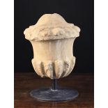 A 17th Century Carved Limestone Architecture Finial in the form of a gadrooned urn,