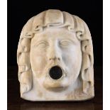 An Antique Carved White Marble Face Mask forming the Mount for a Wall Fountain.