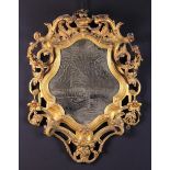 An 18th Century Cartouche-shaped Wall Mirror in a gilt gesso-work frame decorated with crested