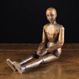 A Small Late 19th Century Wooden Artist's Lay Figure having articulated limbs, and a carved face,