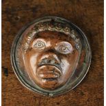 A Venetian Renaissance Bronze Door Mount embossed with the face of a Nubian protruding from a