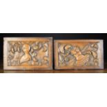 A Pair of Carved Panels depicting a cuirass and close helmet entwined with scrolling acanthus