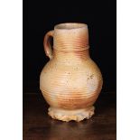 A 13th/14th Century Siegburg Salt-glazed Stoneware Baluster Jug with ribbed cylindrical neck and