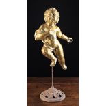 A Late 18th Century Hollow Cast Gilt Metal Celestial Cherub with windswept curly hair,