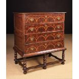 An 18th Century Oak Two-Part Chest on Stand having an oyster veneered facade inlaid with satinwood