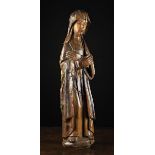A 15th Century Carved Oak Sculpture, possibly St Anne depicted wearing a wimple and long robe,