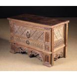 A Low 'Gothic' Oak Chest of Drawers richly carved in the French early 16th century style with