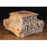 An Antique Carved Wooden Capital inverted and centred by a pricket spike within a circular well,