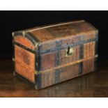 A Small Dome-topped Travelling Chest clad in crocodile skin and bound with iron straps.