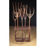 A Collection of Five Rustic Pitchforks and a vintage soil riddle.