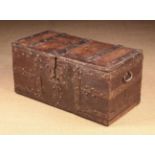 A 16th Century Boarded Oak Chest of rectangular form bound in studded iron straps with fleur-de-lis