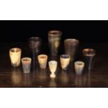 Five 18th/Early 19th Century Horn Beakers of plain tapering form, one with an inset glass base,