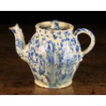 A Wetherigg's Pottery Teapot with stippled blue glaze on a cream glazed ground and sgrafitto