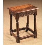 A 17th Century Oak Joint Stool with lunette carved frieze and gun barrel turned legs united by