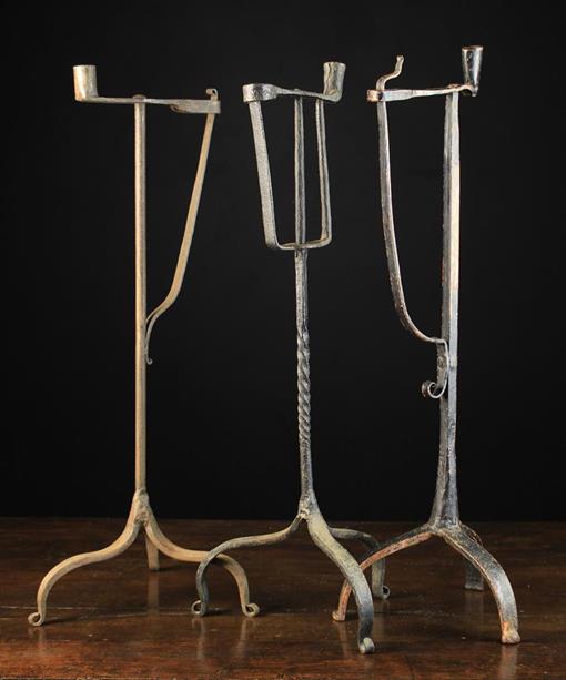 Three 18th Century Style Wrought iron Peermen with sprung rush holders and candle-sockets on tripod