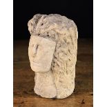 An Antique Carved Stone Head, 9½" (24 cm) in height.