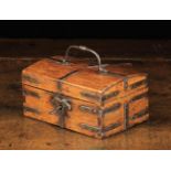 A Small 18th Century Wooden Casket bound in steel straps with a swing handle to the slightly domed