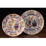 Two 18th Century Polychrome Delft Plates decorated with vases of flowers and stylised flower,