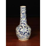 A Chinese Blue & White Bottle Vase decorated with birds and butterflies amongst flowering foliage