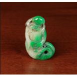 An Oriental Jade Pendant carved as a rén yú; the bearded figure with forked fish tail,