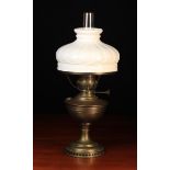 A Brass Oil Lamp with glass chimney and moulded white glass shade, 23" (58 cm) overall in height.