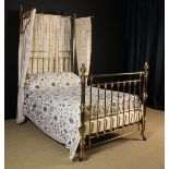 A Victorian Brass Half Tester Bed, with divan and mattress, 92½" (235 cm) high, 55" (140 cm) wide,