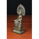 A Small Antique Cast Bronze Buddha sat upon a coiled serpent with seven headed canopy,