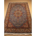 A Fine Late 20th Century Persian Carpet woven with a profusions of flowers surrounding a central
