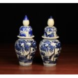 A Pair of 19th Century Japanese Blue & White Lidded Vases decorated with birds and foliage.