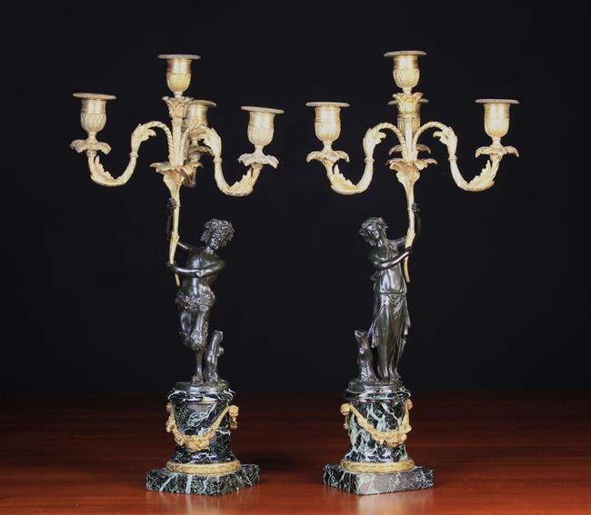 A Pair of 19th Century Figural Bronze Candelabra after Clodion.