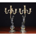 A Pair of 19th Century Figural Bronze Candelabra after Clodion.