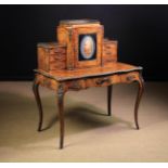 A 19th Century Figured Walnut Bonheur du Jour with diagonally grained tulipwood borders edged with