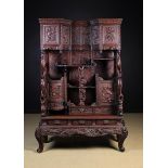 A Large Early 20th Century Japanese Lacquered Cabinet on Stand elaborately carved with flowers,