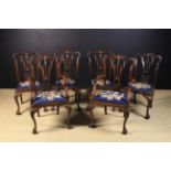 A Set of Six Carved Mahogany Chippendale Style Dining Chairs, including two Armchairs.