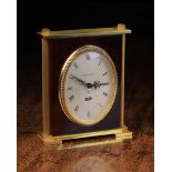 A Small Jaegar-LeCoultre Eight Day Alarm Clock with oval dial set in a rectangular simulated