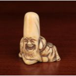 A 19th Century Netsuke carved as a Laughing Fukurokuju, 55 mm high.