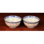 A Pair of Chinese Rice Bowls decorated with underglaze blue floral sprays to centre panels,