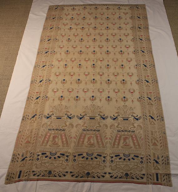 An Antique Embroidered Mulsin Drape woven with repeated Egyptianesque motifs in beige enhanced with