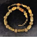 A Japanese Bead Necklace composed of a collection of signed Meiji period mixed metal Ojime beads