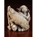 A 19th Century Signed Japanese Ivory Okimono carved swith a wild boar & two figures, signed on base,