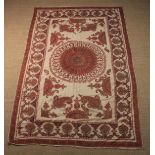 An Antique Indian Hand-made Table Cloth intricately embroidered predominantly in red enhanced with