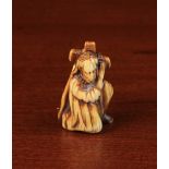 A Medieval Carved Antler Pilgrim's Charm in the form of Christ carrying the Cross, 2" (5 cm) tall.