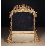 A Decorative 19th Century Giltwood Overmantel Mirror in the Louis XV Style.
